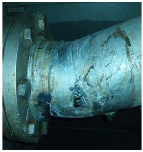 Corroded scrubber pipe section prepared for leak repair